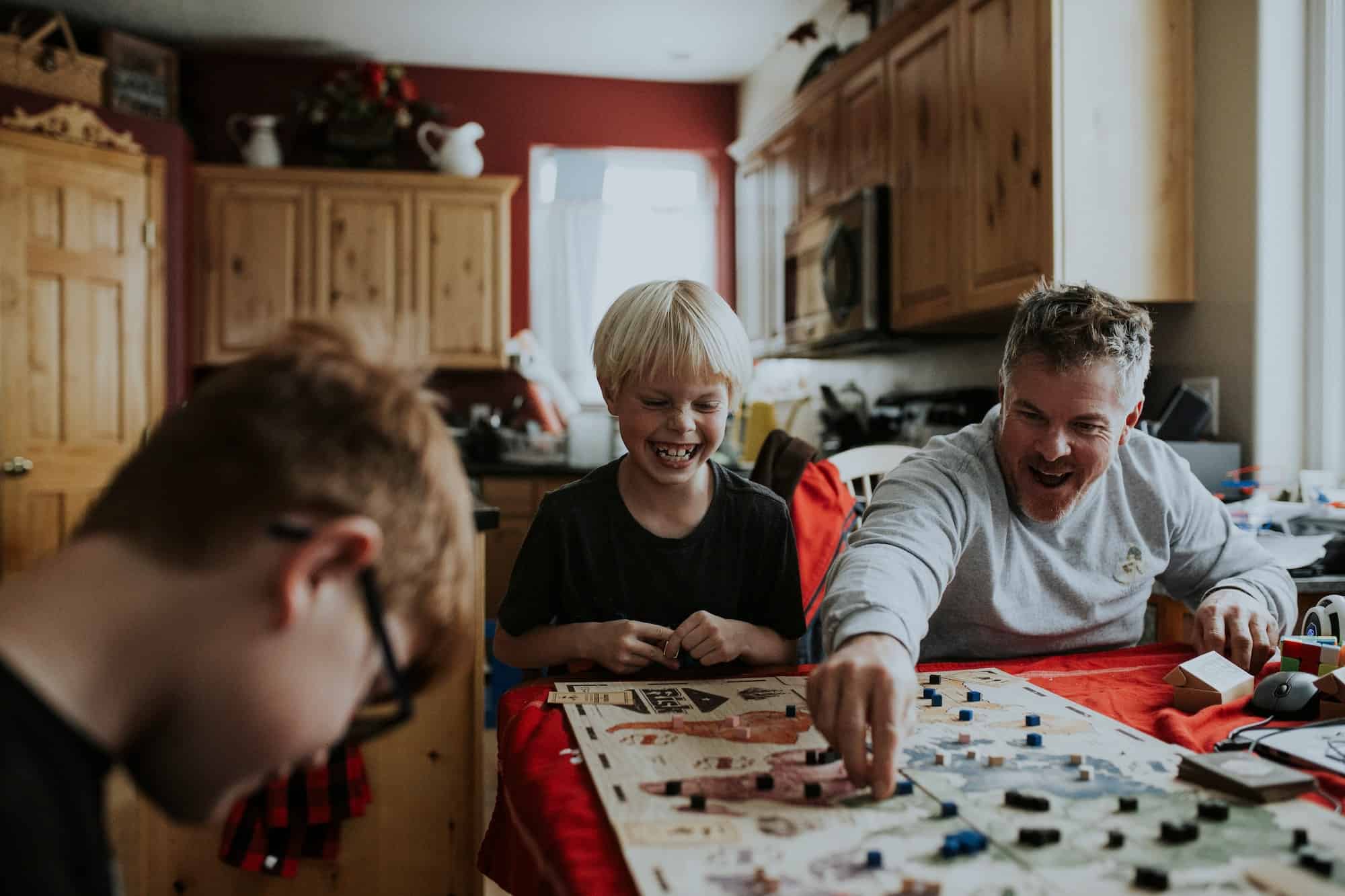 family playing board game together
